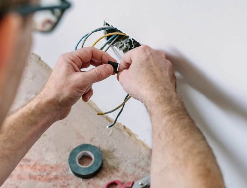 Electrician working on the electrical installation of a house commercial electrician Newcastle