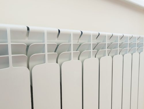 White aluminum radiator heating panel in the interior.